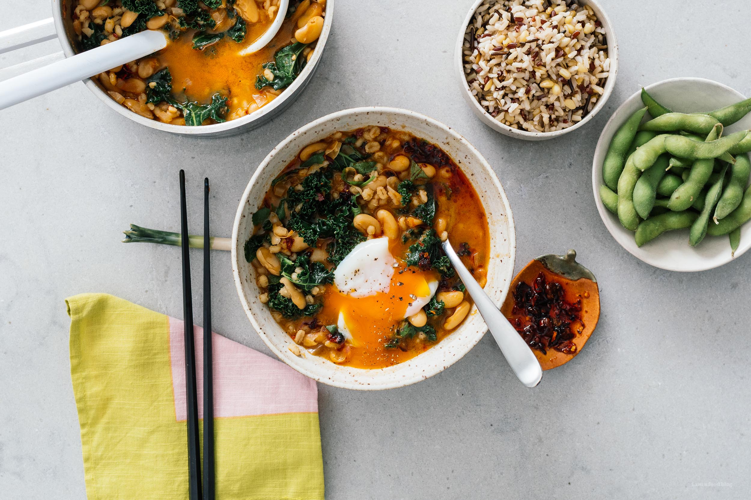 Spicy Chili Crisp White Bean and Barley Stew with Kale and Eggs